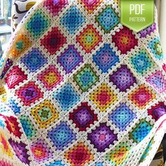 a colorful crocheted blanket sitting on top of a chair