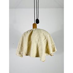 a light that is hanging from a wire with a cloth on it and two cords attached to the cord