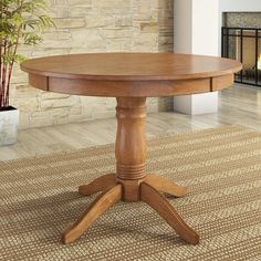 a wooden table sitting on top of a carpeted floor next to a fire place