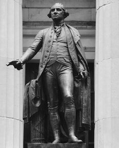 the statue of george washington stands in front of a building