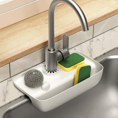 a kitchen sink with sponges in it