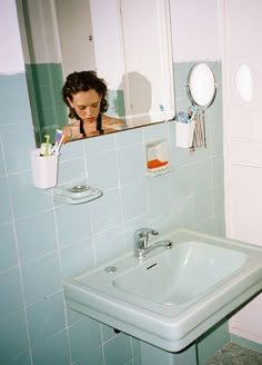 a woman is taking a selfie in the bathroom mirror