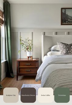 a bedroom with white bedding, green curtains and wooden nightstand in front of window