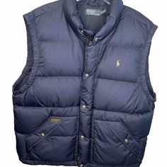 Enhance Your Style With This Polo By Ralph Lauren Quilted Blue Puffer Vest In Size 2xl. The Vest Is Made Of A Cotton Blend Outer Shell Material With A Nylon Poly Blend Lining Material That Gives You Warmth And Comfort In Chilly Weather. The Vest Features A Zip And Snap Closure And Has Accents Of Quilted Design That Adds To Its Beauty. This Vintage Vest Is Perfect For Men Who Love To Flaunt Their Style. It Is A Regular Size Type Vest That Can Be Worn On Any Occasion. The Vest Is A Great Addition Blue Puffer Vest, Ralph Lauren Vest, Blue Puffer, Vintage Vest, Blue Quilts, Chilly Weather, Puffer Vest, Polo By Ralph Lauren, Snap Closure