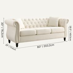 a white couch is shown with measurements for it