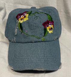 This floral heart garland is hand embroidered on a 100% cotton distressed baseball cap . One size fits all, with Velcro adjustable back . Adjustable Cotton Hats For Spring, Adjustable Cotton Spring Hats, Adjustable Cotton Hat With Embroidered Patch, Cotton Summer Hats For Gift, Cotton Summer Hats As Gifts, Summer Cotton Hats For Gifts, Summer Cotton Hats Perfect For Gifts, Summer Cotton Hats As Gifts, Spring Cotton Hats With Floral Embroidery