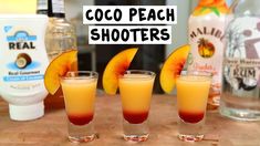 three shot glasses filled with orange juice and peach slices