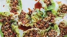 lettuce wraps with walnuts and dressing on a white platter, ready to be eaten