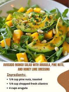 a salad with avocado, mangoes and honey lime dressing in a white bowl