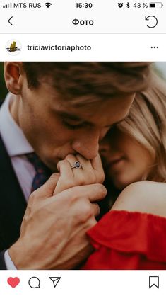 a man and woman holding each other close to one another with their wedding rings on