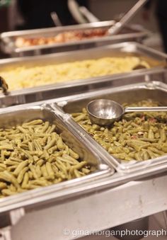 several trays of food with spoons in them