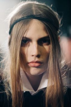 a woman with long hair wearing a headband