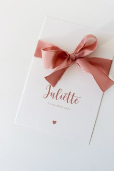 a card with a pink bow and the word jubilee written on it in cursive writing