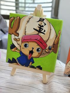 an easel with a painting of a cartoon character on it