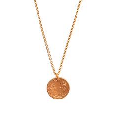 a gold necklace with a coin on it