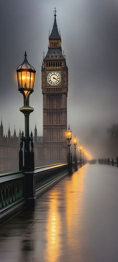 the big ben clock tower towering over the city of london on a foggy day