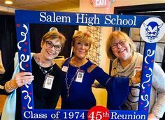 three women pose for a photo in front of the salem high school class of 1974 reunion sign