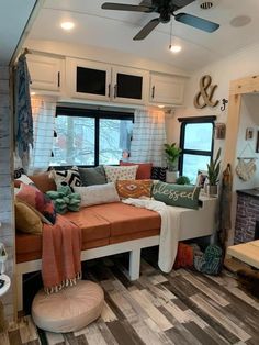 a living room filled with lots of furniture and decor on top of a hard wood floor