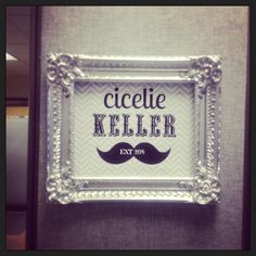 a sign that says cleelie keller next to a wall with a mustache on it