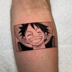 a person with a tattoo on their arm and the image of an anime character behind it