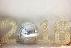 a disco ball sitting on top of a table next to the numbers 2012 and 2013