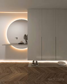 a modern bathroom with white walls and wood flooring, illuminated by round lights on the wall