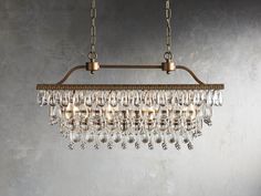 a chandelier hanging from the ceiling with crystal drops on it's sides