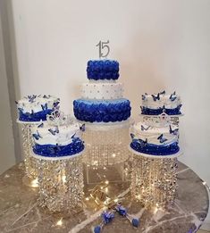 a table topped with lots of blue and white cakes