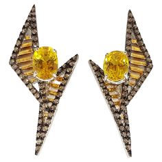 Yellow Sapphire 4.0 carats with Brown Diamond 1.22 carats Earrings set in 18 Karat Gold Settings Width: 1.8 cm Length: 4.0 cm Total Weight: 11.1 grams The ancient Japanese tradition of paper folding has inspired the form and elements of this modern collection. With a series of folds and pleats, each piece reveals a distinctively arresting visual appeal at all angles. (KENNY) & SHAR-LINN, KAVANT & SHARART IS A FINE JEWELRY BRAND TAILORED TO MEET THE DISCERNING NEEDS OF THE STYLE SOPHISTICATE. THE CORE TO KAVANT & SHARART'S AESTHETICS AND PHILOSOPHY IS A PIECE OF JEWELRY SHOULD NOT ONLY SATISFY THE WEARER'S NEED FOR SOMETHING BEAUTIFUL, BUT ALSO HER DESIRE FOR SOMETHING ORIGINAL THAT HIGHLIGHTS HER PERSONALITY. KAVANT & SHARART'S DESIGN ETHOS STATES JEWELRY SHOULD BE TRANSITIONAL AND TIMELES Jeweled Earrings, Different Seasons, Paper Folding, Brown Diamond, Jewelry Brand, Yellow Sapphire, Something Beautiful, Earrings Set, Jewelry Branding