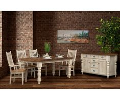 a dining room table and chairs in front of a brick wall with potted plant