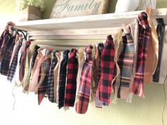 a bunch of scarves hanging from a shelf