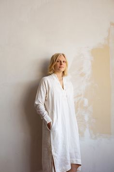 Relaxed off white linen dress with delicate light brown hand embroidery throughout. Hidden button closure at notch neck, buttoned cuffs, side seam pockets, and side slits at hem. Handmade in India. 100% Linen. Hand wash and lay flat to dry. Erica Tanov Hand Embroidered Dress, Dress For Everyday, White Linen Dress, White Linen Dresses, Mid Dresses, Linen Dress, Embroidered Dress, White Linen, Hand Embroidered