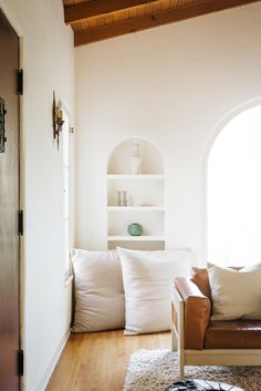 a living room with white walls and wooden floors