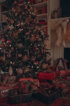 a christmas tree with presents under it