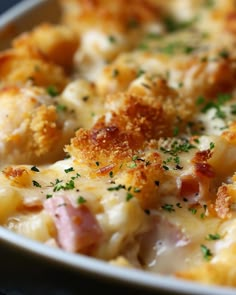 a close up of a plate of food with ham and cheese on it, garnished with parmesan sprinkles