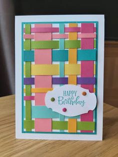 a birthday card made with colored strips and a tag on the front that says happy birthday