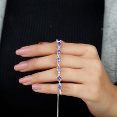 Product Details Express your love to your loved one on Valentines Day by presenting this Tanzanite Link Bolo East West Bracelet. This Tanzanite Bracelet is perfectly adorned with Oval Cut Tanzanite in Prong Setting. Product Information SKU SHP-BRACELET0621104597 Length 177.8 mm Width 4 mm Height 2.5 mm Weight 6.30 gm (Approximate) TANZANITE INFORMATION No.of Stones 9 Pieces Total Weight 4.86 Carat (Approximate) Dimension(approx) Oval-4X6 mm-9 Pcs Color Blue Cut Brilliant Shape Oval Setting Type Tanzanite Bracelet, Oval Setting, Bolo Bracelet, East West, Oval Cut, Oval Shape, Prong Setting, Valentines Day, White Gold