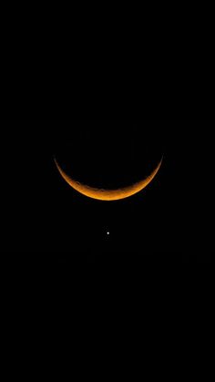 an orange crescent eclipse in the night sky