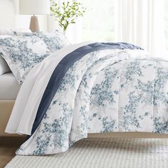 the comforter is made up with blue and white flowers