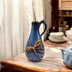 a blue vase sitting on top of a wooden table