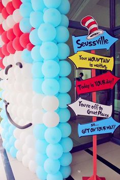 the cat in the hat balloon is next to a sign that says you're off to get your way