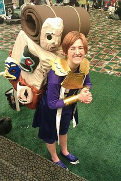 a woman standing next to a giant stuffed animal