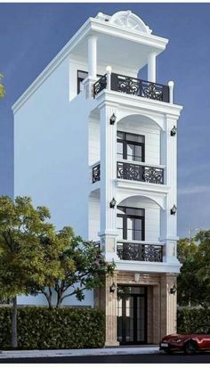 a large white building with balconies on the second floor