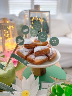 there are many donuts that are on the cake plate with little signs in front of them