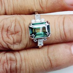 ❤Custom Order Always Welcome❤ STONE DETAILS Gem Type: Moissanite Center Stone: Moissanite Stone Shape: Emerald Cut Stone Color: Green Clarity: VVS1 Stone Wight: 2.77 Ct (Approx) Side Stone: Cubic Zirconia Guarantee: Test Positive & Life time Brilliance Main Stone Creation: Lab Created Durability: Tougher Than Diamond Impervious To Heat & Chemical RING DETAILS Metal Color : As Per Picture Metal Purity : 10k Yellow Gold Metal Stamp: 10k Style : Solitaire With Accents MOISSANITE DESCRIPTION Luxury Green Moissanite Emerald Ring, Luxury Green Emerald-cut Diamond Ring, Green Emerald-cut Ring With Birthstone Detail, Green Emerald-cut Platinum Halo Ring, Green Moissanite Ring, Green Emerald-cut Crystal Ring With Center Stone, Green Moissanite Engagement Ring, Antique Wedding Ring, Green Moissanite