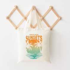 Looking for a cute tote bag to carry all your essentials this summer? This cute Chasing Sunset Vintage bag will be perfect to add to your collection. Perfect for a day at the beach or every day life! Summer Rectangular Canvas Bag With Letter Print, Retro Summer Beach Bag For Travel, Retro Summer Canvas Bag For Everyday, Retro Summer Canvas Bag, Summer Canvas Shoulder Bag With Letter Print, Summer Canvas Gift Bag, Summer Style Canvas Gift Bag, Retro Summer Travel Canvas Bag, Retro Summer Canvas Travel Bag