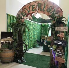 the entrance to an event decorated with plants and decorations