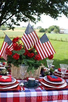 a table set with red, white and blue place settings