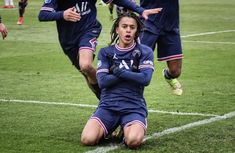 the soccer players are on the field during a game, and one player is injured