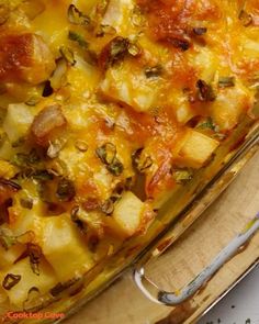 a casserole dish with potatoes, cheese and herbs